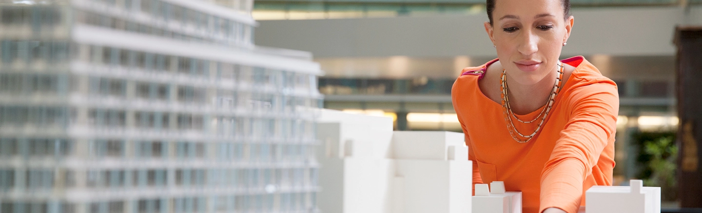 Woman working on model of a building