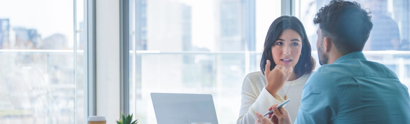Man and woman working and talking in office
