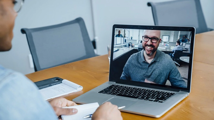 Man talking to man via video call on lap top