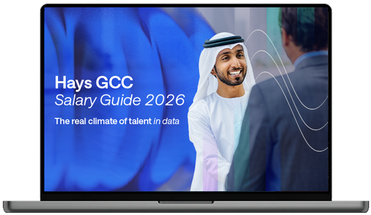 Laptop displaying the Hays GCC Salary Guide 2026 cover with text stating ‘The real climate of talent in data’ and abstract wave graphics.